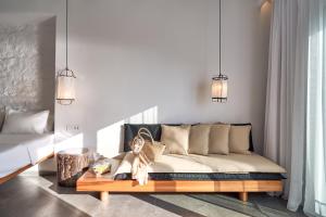 a living room with a couch and a table at Hippie Chic Hotel in Agios Ioannis Mykonos