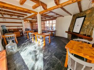 a restaurant with wooden tables and chairs in a room at Hosteria Las Lucarnas in San Martín de los Andes