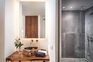 a bathroom with a sink and a shower at Hippie Chic Hotel in Agios Ioannis Mykonos