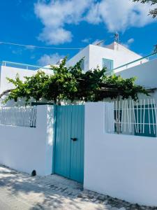a white house with a blue door and white walls at Lilika's Luxury Maisonette by Estia in Hersonissos