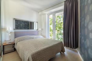 Posteľ alebo postele v izbe v ubytovaní Spa Residence Carbona Hévíz Apartments KAKADU 203 A