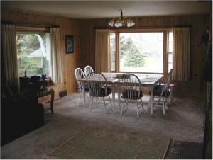 a dining room with a wooden table and chairs at El Dorado Ranch in Custer