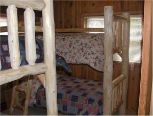 a bedroom with two bunk beds in a cabin at El Dorado Ranch in Custer