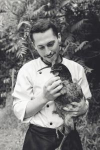 a man holding a bird in his hands at Hotel Restaurant La Musardiere in Giverny