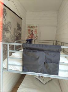 a bedroom with a bunk bed with white pillows at Ty West in Batz-sur-Mer