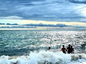 a group of people in the water at the beach at Ty West in Batz-sur-Mer +1 photo