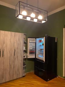 a refrigerator with its door open in a room at Corner Guest House in Tbilisi City
