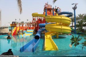 a water park with a slide in the water at Lagoona Beach Luxury Resort and Spa in Manama