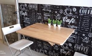 a table in a coffee shop with a chalkboard wall at Liber Guest House in Braga