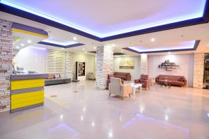 a lobby of a hospital with couches and chairs at Rose Garden Apart Hotel in Alanya