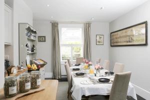 a dining room with a table and chairs at Saddlers B&B in Funtington