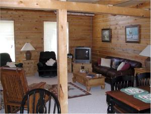 a living room with a couch and a tv at Comanche Lodge in Custer