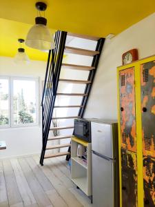 a kitchen with a staircase and a refrigerator at Le Paddle - station balnéaire Les Sablettes in La Seyne-sur-Mer