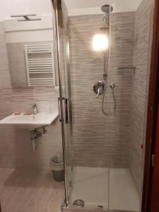 a bathroom with a shower and a sink at Hotel La Torre in Cogoleto