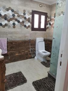a bathroom with a toilet and a window at Cairo Egypt Al Rehab amazing Flat in Cairo