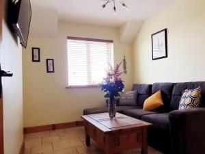 a living room with a couch and a table at Seaview Apt in Buncrana with balcony in Buncrana