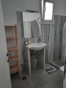 a bathroom with a sink and a mirror at Moschoula Studios in Parikia