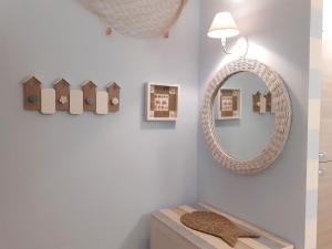a bathroom with a mirror and a wooden table at I Velieri in Cesenatico