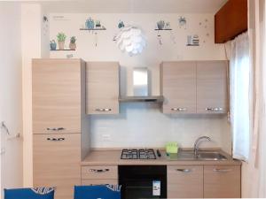 a kitchen with wooden cabinets and a stove top oven at I Velieri in Cesenatico