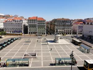 a large plaza in a city with cars and buses at Figueira House in Beira Minho in Lisbon