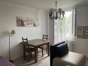 a dining room with a table and a chair at Appartement 2/3 personnes à 10 minutes de Contis plage (Saint Julien en Born) in Saint-Julien-en-Born