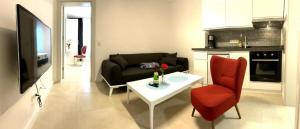a living room with a couch and a table at Gepflegtes und schönes Ferienapartment in Travemünde
