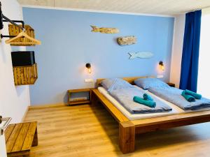 a bedroom with a bed with two teddy bears on it at Ankerix & Deichfix in Büsum