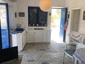 a white kitchen with a sink and a mirror at Aegean Dream 3 in Agia Marina