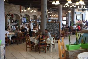 a group of people sitting at tables in a restaurant at Resort Nord Park in Fushë-Krujë