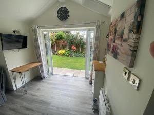 a hallway with a door leading to a yard at Rose View- a lovely private 1 Bed Bungalow in Sale in Sale