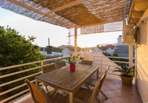 a wooden table and chairs on a balcony at Apartment Marlo in Dubrovnik
