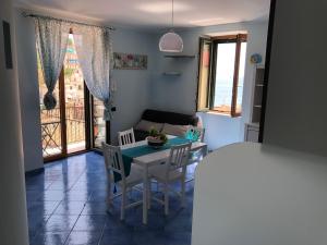 a living room with a table and chairs and a couch at NEL BLU in Cetara