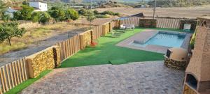 a backyard with a swimming pool and a fence at Casa-Grima in Grima