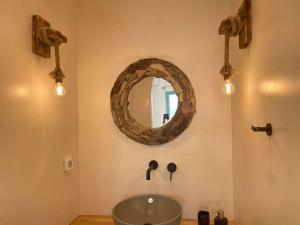 bagno con lavandino e specchio a parete di Deco Suites a Naxos Chora