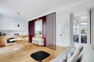 a living room with a couch and a table at Pick A Flat's Apartment in Marais/Oberkampf - bvd du Temple in Paris