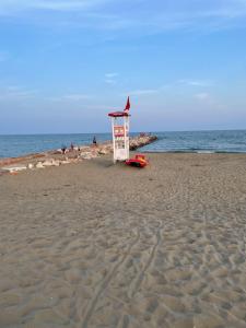 a lifeguard tower on a beach with the ocean at Eraclea Palace Hotel 4 stelle S in Eraclea Mare