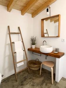 a bathroom with a sink and a mirror at São Vicente in Vila Nova de Milfontes