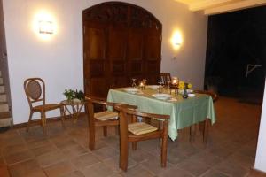 a dining room with a table with a green table cloth at Villa Sunrise Ferienhaus in Tangalle +9 photos