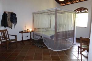 a bedroom with a bed with a mosquito net at Villa Sunrise Ferienhaus in Tangalle