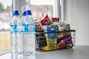 two bottles of water sitting next to a basket of snacks at The Ark 1 Christchurch in Holdenhurst