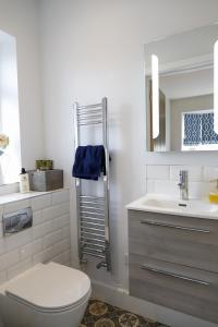 a bathroom with a toilet and a sink at The Ark 1 Christchurch in Holdenhurst