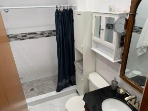 a bathroom with a sink and a shower at Chambres EL MEDITERRANEO Rooms in Montreal