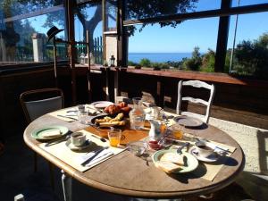 a wooden table with food on it on a patio at La Quercia Agriturismo in Imperia