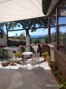 a patio with chairs and a table with a view at La Quercia Agriturismo in Imperia