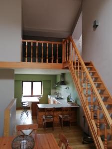 eine Küche und ein Esszimmer mit einer Treppe in einem Haus in der Unterkunft Bienvenue en Gaume ! in Izel