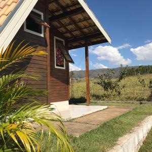 a porch of a house with a view of the mountains at Chalé Flor Da Serra in São José do Barreiro