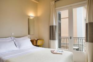 A bed or beds in a room at Athena hotel