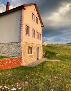 a house in the middle of a field at Guest House Nena in Žabljak