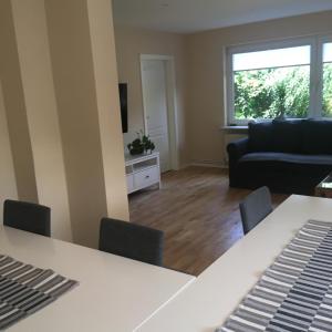 a living room with a table and a couch at Landhaus von Frieling - Neuenkirchen in Neuenkirchen