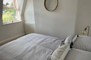 a bedroom with a bed with a mirror on the wall at Apartment with stunning views of Menai Strait. in Menai Bridge